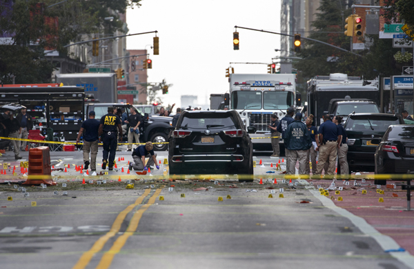 Crime scene investigators work at the scene of an explosion on West 23rd Street in Manhattan's Chelsea neighbourhood, in New York, on Sunday, after an incident that injured passers-by on Saturday night (AP photo)